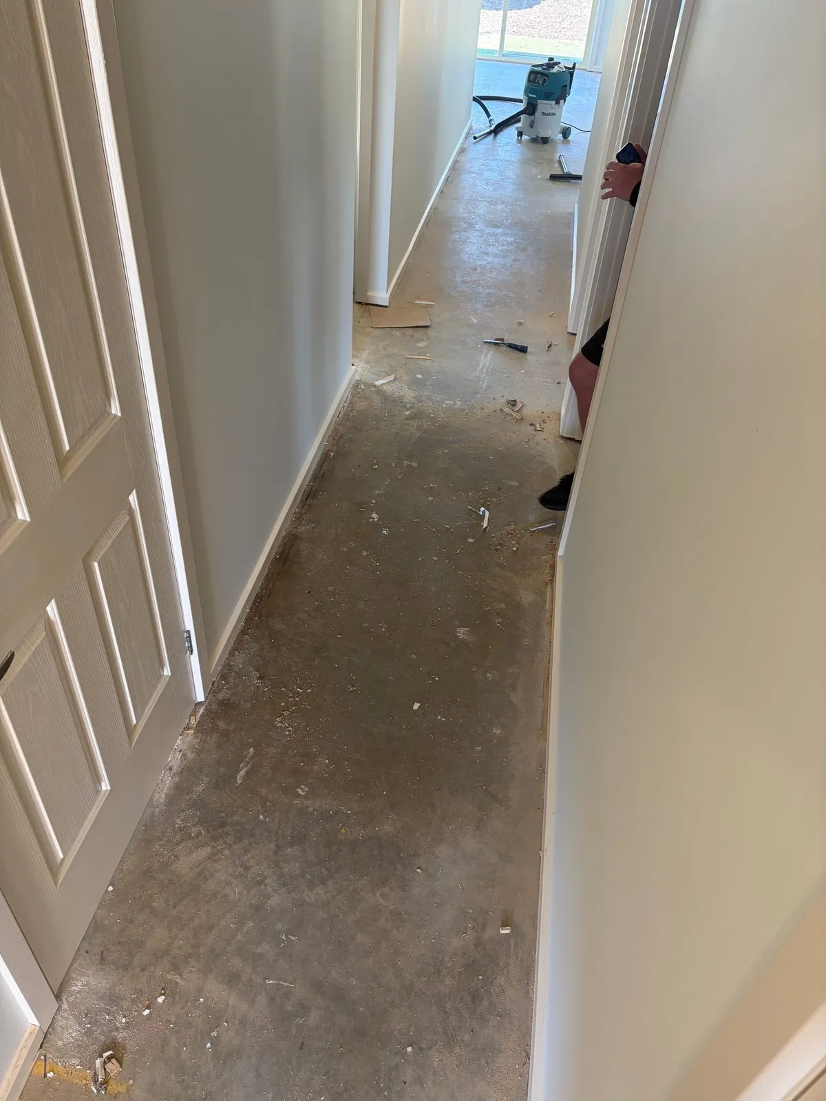Old flooring being removed to expose the subfloor beneath